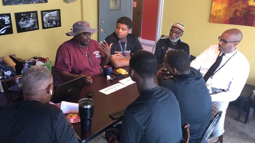 Community activist Marlon Shackelford talks to students and school and city leaders July 30 at the Third Perk Coffeehouse & Wine Bar downtown, discussing efforts to help more young black students succeed in life. JEREMY P. KELLEY / STAFF