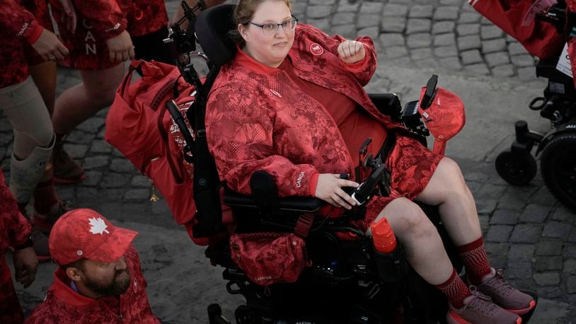 FILE - Alison Levine, a Paralympian who competes in the sport of boccia, parades with fellow athletes in the Paralympics Opening Ceremony from Team Canada in Paris, Wednesday Aug. 28, 2024. Levine and teammates are dressed in uniforms designed by Lululemon with adaptive fashion in mind. (AP Photo/Aurelien Morissard, File)