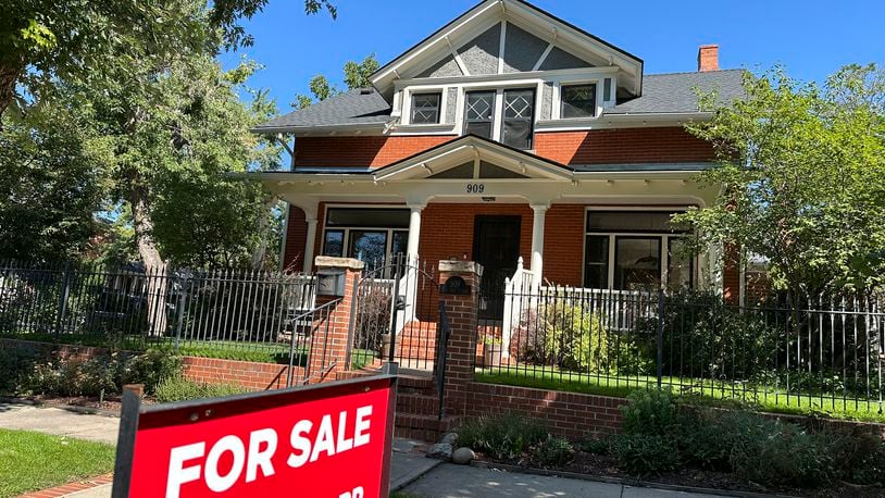 A for sale sign stands outside a home on the market in the Alamo Placita neighborhood Tuesday, Aug. 27, 2024, in central Denver. (AP Photo/David Zalubowski)