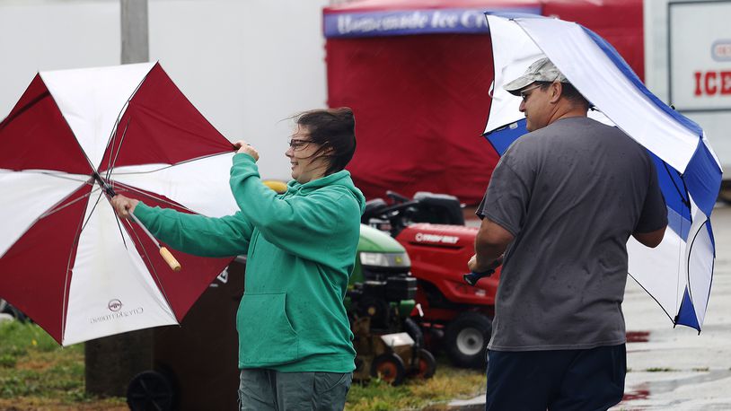 Jody and Stephen Harner battle the effects from Hurricane Helene , Friday, Sept. 27, 2024 at the 53rd Aunnual Old Timers Festival at the Greene County Fairgrounds and Expo Center. MARSHALL GORBY\STAFF