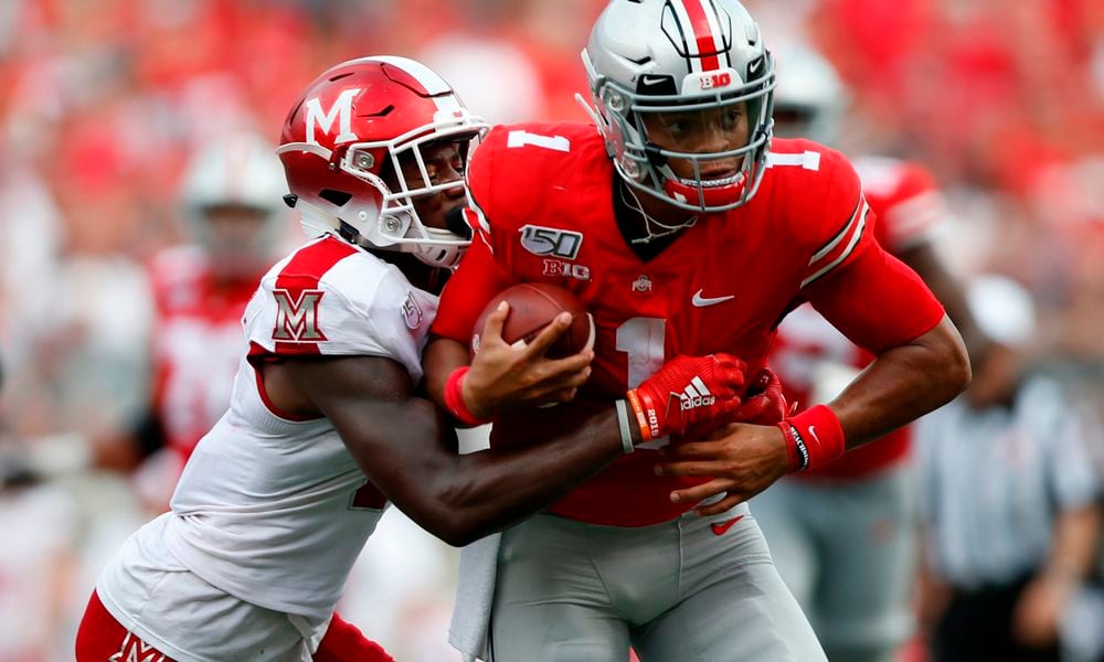 Quarterback Justin Fields (1) of the Ohio State Buckeyes runs through defensive back Cecil Singleton (2) of the Miami (Oh) Redhawks during the second quarter of the game between the Ohio State Buckeyes and the Miami (Oh) Redhawks at Ohio Stadium in Columbus, Ohio on Saturday, September 21, 2019. (Maddie Schroeder/Dispatch/TNS)