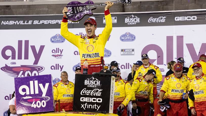 Joey Logano, top, celebrates after winning a NASCAR Cup Series auto race, Sunday, June 30, 2024, in Gladeville, Tenn. (AP Photo/Wade Payne)