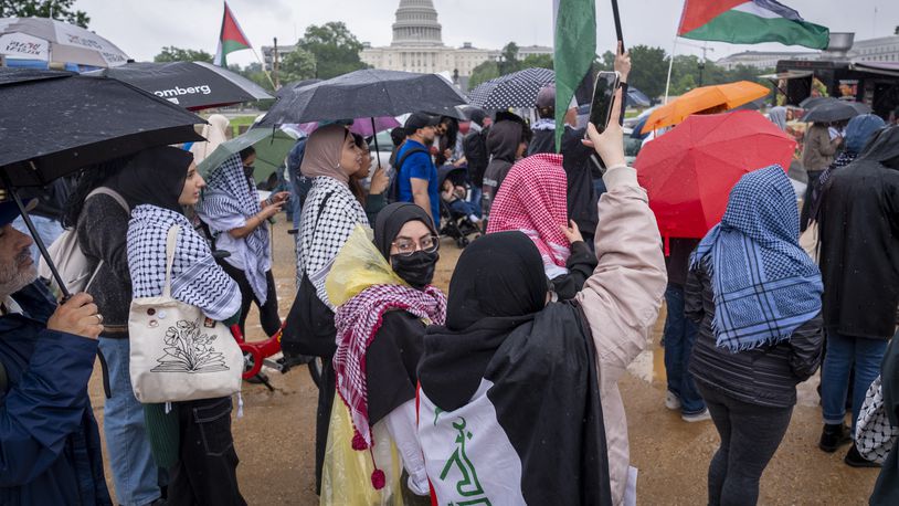 People hold Palestinian flags while attending a pro-Palestinian rally, Saturday, May 18, 2024, on the National Mall near the Capitol in Washington. (AP Photo/Jacquelyn Martin)