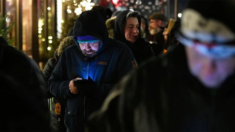 A long line of people brave the cold as they wait to be the first in Illinois to purchase recreational marijuana at Sunnyside dispensary Wednesday, Jan. 1, 2020, in Chicago.