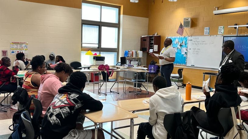 Donerik Black, Learn to Earn's Manager of Place-Based Strategies, talks with students at a Dayton Public school about the student vision initiative. Courtesy of Learn to Earn