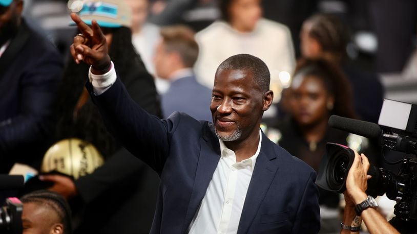 Dayton's Anthony Grant points to fans in the stands after DaRon Holmes II was selected with the No. 22 pick in the NBA Draft on Wednesday, June 26, 2024, at the Barclays Center in Brooklyn, N.Y. David Jablonski/Staff