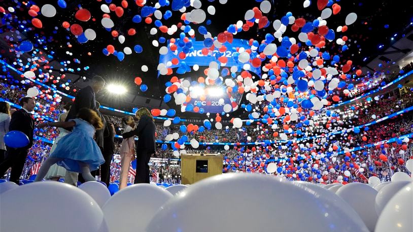 Democratic presidential nominee Vice President Kamala Harris, second gentleman Doug Emhoff, Democratic vice presidential candidate Minnesota Gov. Tim Walz and his wife Gwen Walz and members of their families stand on stage as balloons drop on the final night of the Democratic National Convention in Chicago, Thursday, Aug. 22, 2024. (Kent Nishimura/The New York Times via AP, Pool)