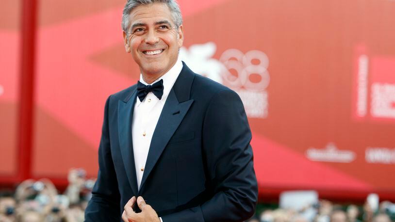 FILE - George Clooney poses on the red carpet at the premiere of his film "The Ides of March," opening the 68th edition of the Venice Film Festival in Venice, Italy on Aug. 31, 2011. (AP Photo/Andrew Medechini, File)