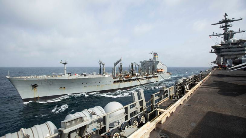 This handout photo from the U.S. Navy shows the Henry J. Kaiser-class fleet replenishment oiler USNS Big Horn sailing alongside the aircraft carrier USS Abraham Lincoln on Sept. 11, 2024, at an undisclosed location at sea in the Middle East. The Big Horn sustained damage in an incident which is under investigation, officials said Tuesday, Sept. 24, 2024. (U.S. Navy via AP)