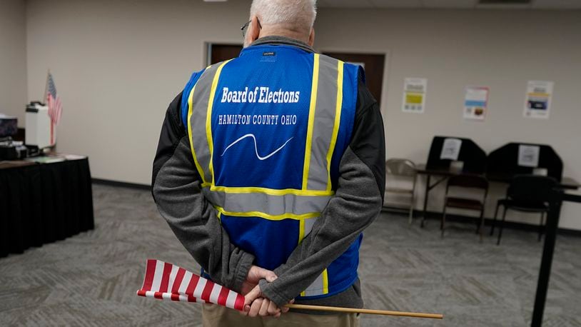 Poll worker Paul Sharp stands by to help voters during early in-person voting at the Hamilton County Board of Elections in Cincinnati, Wednesday, Oct. 11, 2023. (AP Photo/Carolyn Kaster)