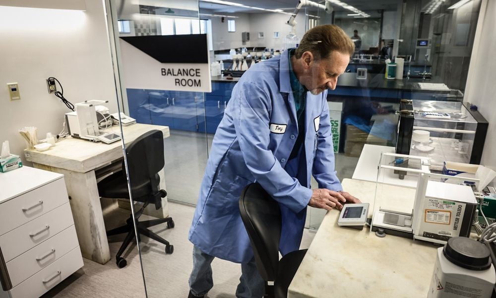 Montgomery County Environmental chemist Tony Miley uses a scale to weigh chemicals at the new Montgomery County Environmental Service lab. The new multi-million dollar lab located in the basement of park garage adjacent to the Montgomery County administration building. JIM NOELKER/STAFF