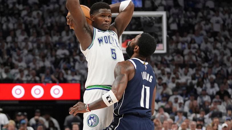 Minnesota Timberwolves guard Anthony Edwards (5) looks to pass over Dallas Mavericks guard Kyrie Irving (11) during the second half in Game 1 of the NBA basketball Western Conference finals, Wednesday, May 22, 2024, in Minneapolis. (AP Photo/Abbie Parr)