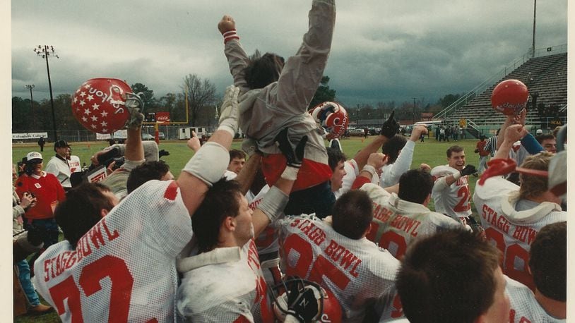 The Dayton Flyers and head coach Mike Kelly celebrate moments after winning the Division III national championship game. University of Dayton Athletics photo