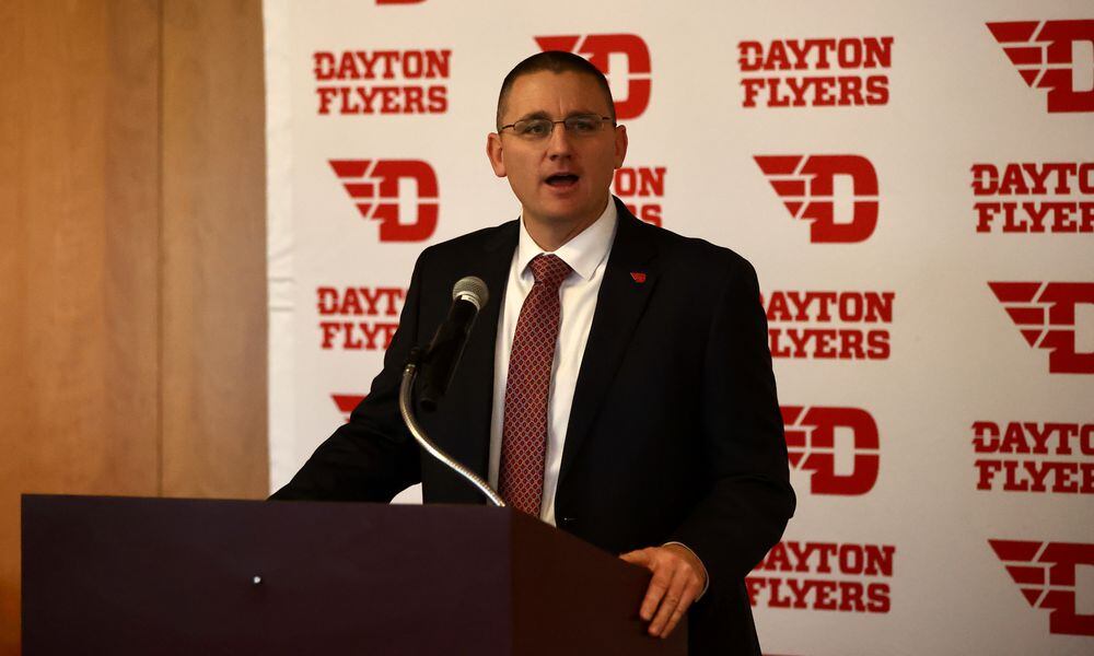 Neil Sullivan introduces Trevor Andrews as Dayton head football coach on Wednesday, Dec. 14, 2022, at UD Arena. David Jablonski/Staff