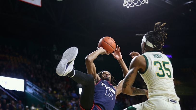 Dayton's DaRon Holmes II scores as he's fouled in the first half against George Mason on Wednesday, Feb. 21, 2024, at EagleBank Arena in Fairfax, Va. He completed the 3-point play. David Jablonski/Staff
