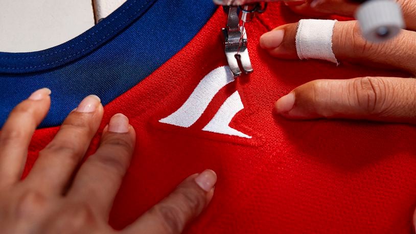 In this handout provided by Fanatics, a Fanatics logo is sewn on the back of a Florida Panthers NHL hockey jersey at the SP Apparel factory in Saint-Hyacinthe, Quebec, Tuesday, June 11, 2024. The NHL unveils new player jerseys for the 2024-25 season made by Fanatics, Wednesday, June 26, 2024, the first time the company has designed and manufactured on-ice/field/court uniforms for a major professional sports league. (Photo courtesy Fanatics via AP)