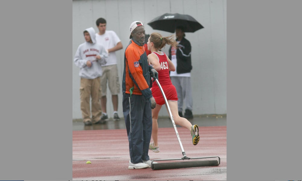 Andre Owings tries to keep the water at bay as the meet continues in the rain during the Don Mitchell Roosevelt Memorial Track and Field Meet at UD's Welcome Stadium on May 2, 2008. Photo by E.L. Hubbard