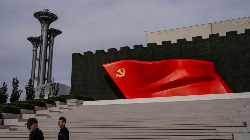 FILE - Visitors pass the Chinese Communist Party flag at the museum of the Communist Party of China in Beijing, Oct. 19, 2023. (AP Photo/Louise Delmotte, File)