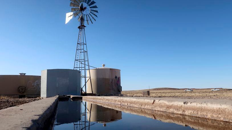 FILE - A windmill draws water for livestock in Leupp, Ariz., on the Navajo Nation, Saturday, March 9, 2024. In a vote on Thursday, May 23, 2024, the Navajo Nation Council has unanimously approved a proposed water rights settlement that carries a price tag larger than any such agreement enacted by Congress. (AP Photo/Felicia Fonseca, File)