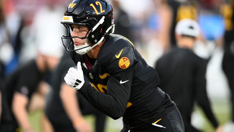 FILE - Washington Commanders wide receiver Luke McCaffrey works out before an NFL preseason football game against the New England Patriots, on Aug. 25, 2024, in Landover, Md. Luke McCaffrey this weekend will become the latest member of his family to play in the NFL. (AP Photo/Nick Wass, File)