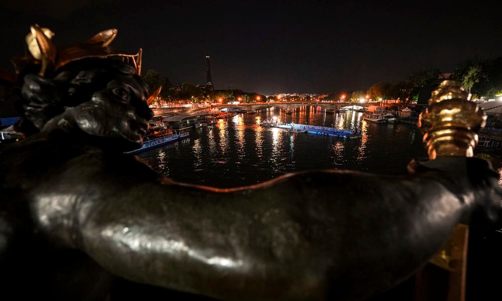 Technicians remove the pontoon for the start of the triathlon events after the event was postponed over concerns about water quality in Paris' Seine River, at the 2024 Summer Olympics, Tuesday, July 30, 2024, at the Pont Alexandre III bridge in Paris, France. (AP Photo/Vadim Ghirda)