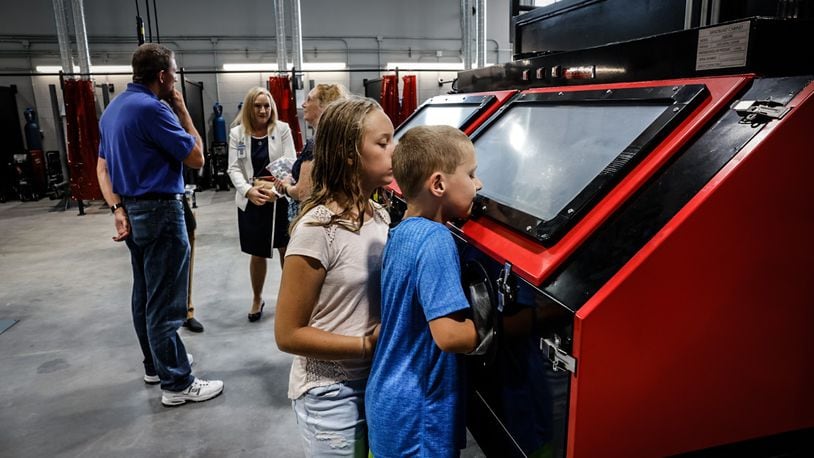 Nate and Sara Dilk check out the Wayne High School Career Tech Center's welding classroom. The new facility will teach three trades: welding, HVAC and construction. JIM NOELKER/STAFF