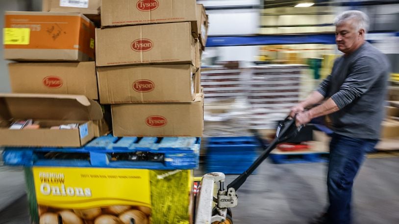 FoodBank employee, Tom Derringer unloads a truck with food from Sam's Club Wednesday March 1, 2023 at the warehouse on Armor Place in Dayton. JIM NOELKER/STAFF