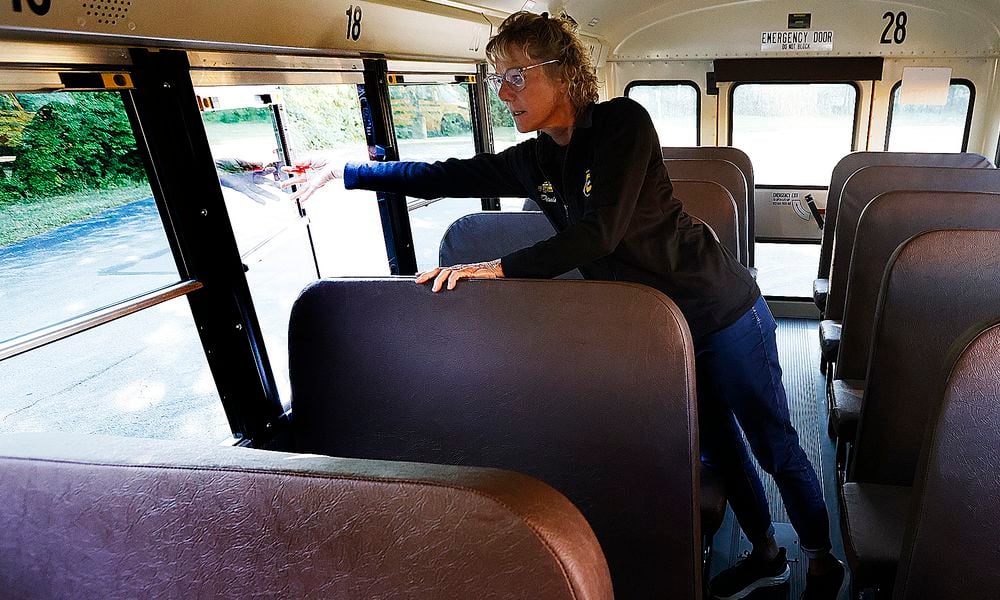 Centerville bus driver Denise Haws checks the emergency exits and goes through her safety checks Tuesday, Aug. 20, 2024 on her bus before picking students. These checks are done every day. MARSHALL GORBY\STAFF