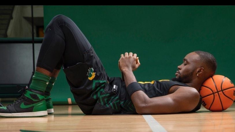 Jack Doumbia lays back in prayer before a practice. “There’s so much more than stats and how many points he averaged,” said Wright State coach Clint Sargent. “If you dig deeper into his past and what he has done, there’s an awful lot there.” CONTRIBUTED