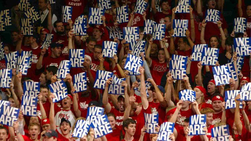 Fans hold up "We Are" signs, as the other half of the crowd holds up "UD" signs, to show their support for the Dayton Flyers in a game at UD Arena in 2004.