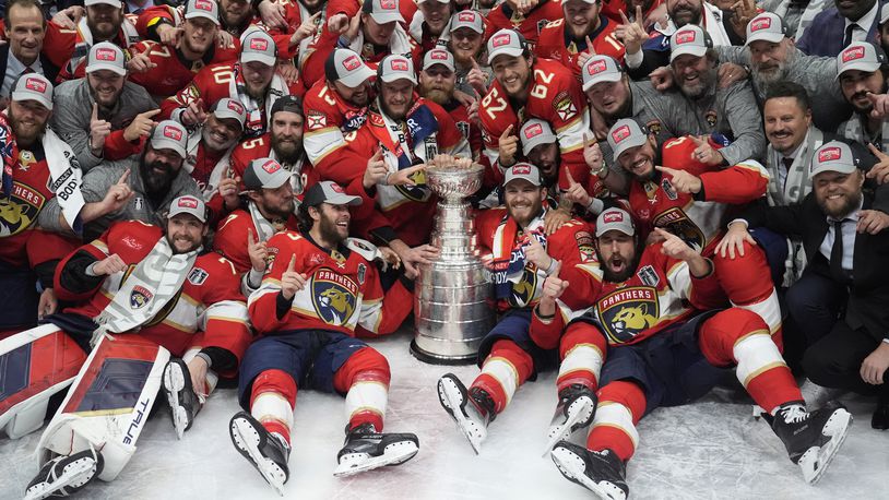 The Florida Panthers team poses with the Stanley Cup trophy after defeating the Edmonton Oilers in Game 7 of the NHL hockey Stanley Cup Final, Monday, June 24, 2024, in Sunrise, Fla. The Panthers defeated the Oilers 2-1. (AP Photo/Wilfredo Lee)