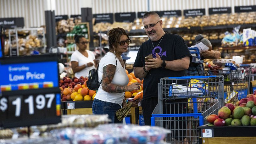 FILE - Shoppers pause in the produce section at a Walmart Superstore in Secaucus, New Jersey, July 11, 2024. (AP Photo/Eduardo Munoz Alvarez, File)