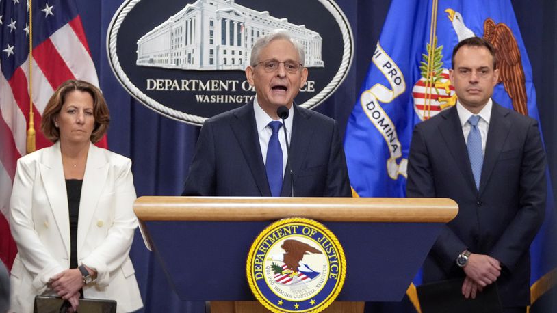 Attorney General Merrick Garland, center, speaks with reporters about an antitrust lawsuit against real estate software company RealPage during a news conference at the Department of Justice, Friday, Aug. 23, 2024, in Washington. At left is Deputy Attorney General Lisa Monaco and at right is Acting Associate Attorney General Benjamin Mizer. (AP Photo/Mark Schiefelbein)