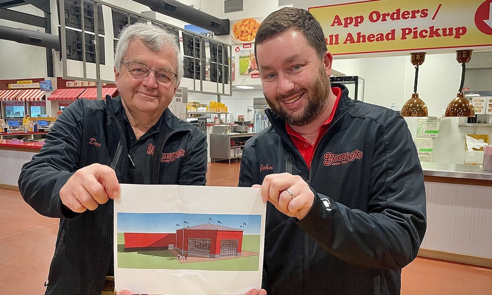 After more than a decade of ideas, Youngs Jersey Dairy has decided to add a carousel and an imagination space for children to a new building that will be constructed on the property. Pictured is Dan Young and his son, John.