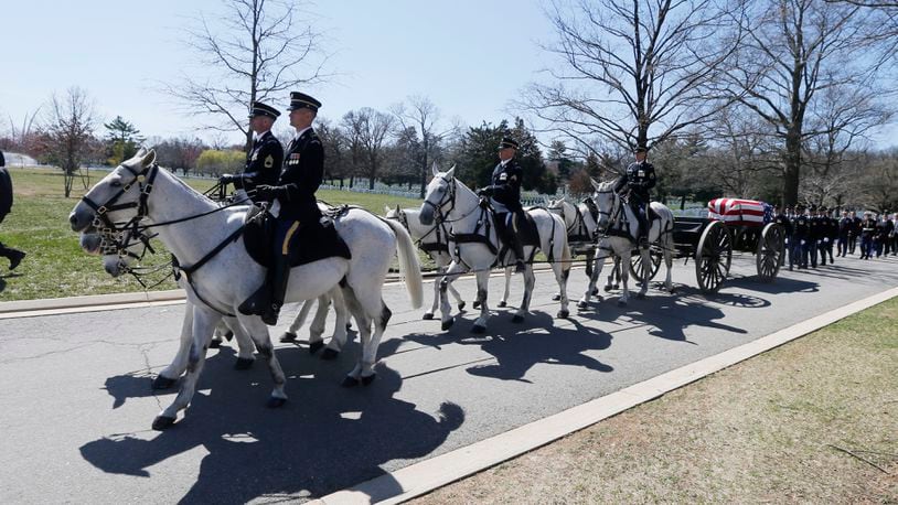 FILE - A U.S. Army Caisson team carries the casket of Lt. Col. Richard Smith during his funeral at Arlington National Cemetery in Arlington, Va., March 28, 2019. The return of horse-drawn caissons at Arlington National Cemetery is being delayed for at least months or a year, the Army said Friday, April 12, 2024, as officials struggle to improve the care of the horses, after two died in 2022 as a result of poor feed and abysmal living conditions. (AP Photo/Steve Helber, File)
