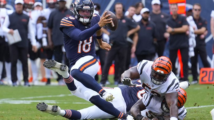 Chicago Bears quarterback Caleb Williams (18) breaks away from a tackle against the Cincinnati Bengals during the first half of an NFL preseason football game, Saturday, Aug. 17, 2024, at Soldier Field in Chicago. (AP Photo/Charles Rex Arbogast)