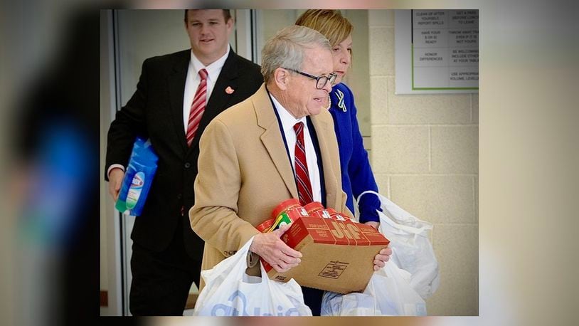 Ohio Gov. Mike DeWine, with first lady Fran DeWine, carry in peanut butter, cleaning supplies, clothes and diapers for children to the Emerge Recovery and Trade Initiative to be transported to help Ukrainian refugees. On Friday, April 1, 2022, the governor met with charitable organizations near Xenia regarding help for Ukrainian refugees. MARSHALL GORBY\STAFF