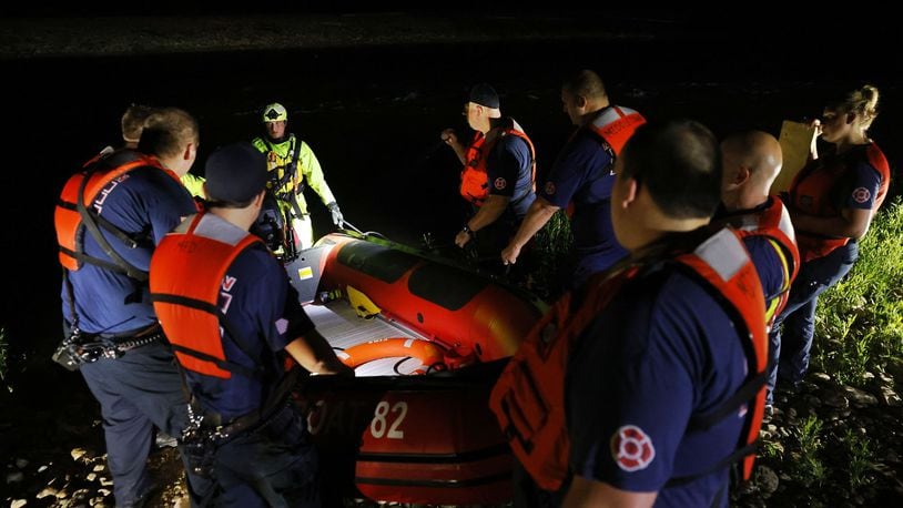 Middletown and Monroe rescue workers searched the Great Miami River north of Germantown Road bridge early Saturday morning on a report a person went into the water and needed rescue help. NICK GRAHAM/STAFF PHOTO