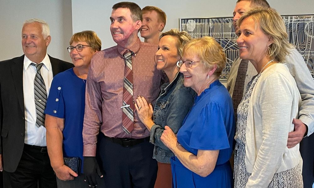 Kevin Pleiman (center) gets his picture taken with his family during a recent event honoring trauma survivors who were treated at Miami Valley Hospital's Level I Trauma Center. SAM WILDOW\STAFF