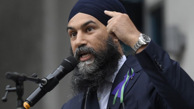 FILE - New Democratic Party leader Jagmeet Singh points to his turban as he speaks about racism during a speech in London, Ontario, June 8, 2021. (Nathan Denette/The Canadian Press via AP, File)