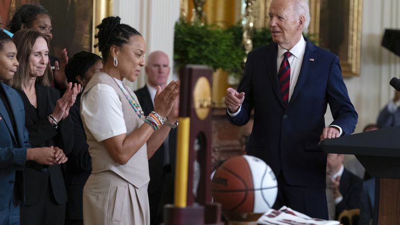 President Joe Biden speaks as the Coach of the University of South Carolina Women's Basketball Team Dawn Staley applauds, in the East Room of the White House in Washington, Tuesday, Sept. 10, 2024, during an event to welcome the University of South Carolina Gamecocks Women's Basketball Team and celebrate their 2023-2024 NCAA championship season. (AP Photo/Jose Luis Magana)