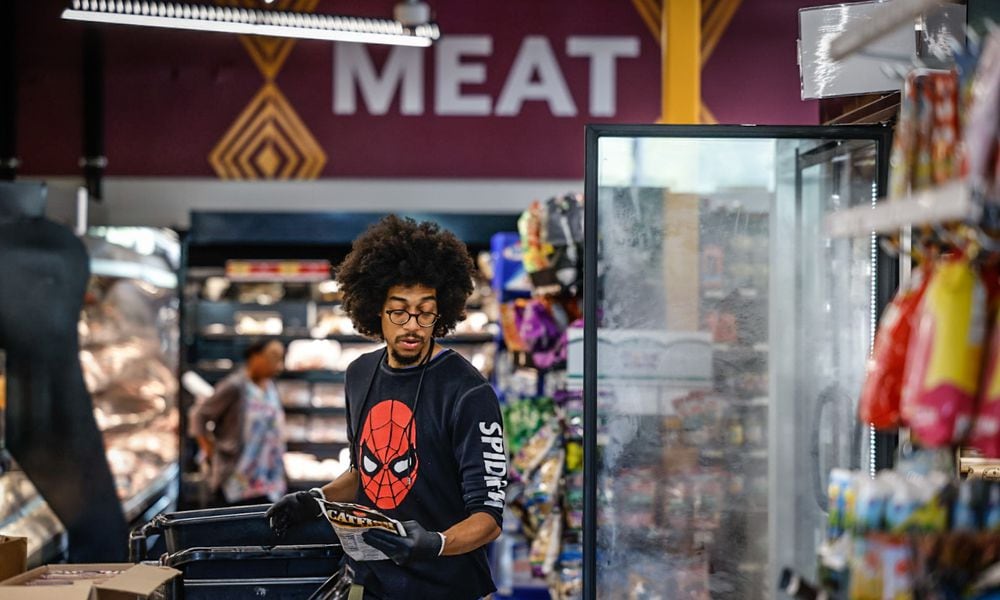 Gem City Market meat manager and butcher, Adrian Harris stocks the shelves Thursday morning September 21, 2023. The market has had a few tough years but plans to turn things around in the next few years. JIM NOELKER/STAFF