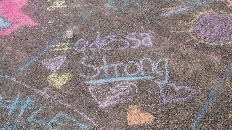 A chalk message at a memorial for victims of a mass shooting, at the University of Texas of the Permian Basin on September 2, 2019, in Odessa, Texas.