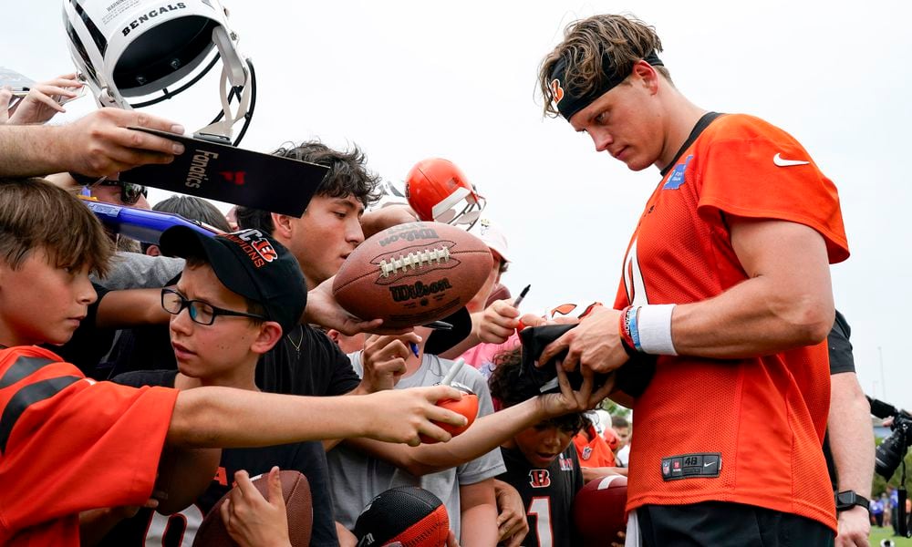 Cincinnati Bengals quarterback Joe Burrow signs autographs during the NFL football team's training camp, Wednesday, July 26, 2023, in Cincinnati. (AP Photo/Jeff Dean)