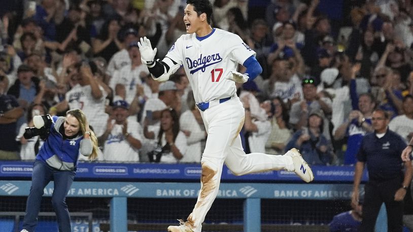 Los Angeles Dodgers designated hitter Shohei Ohtani (17) runs the bases after hitting a grand slam during the ninth inning of a baseball game against the Tampa Bay Rays in Los Angeles, Friday, Aug. 23, 2024. The Dodgers won 7-3. Will Smith, Tommy Edman, and Max Muncy also scored. (AP Photo/Ashley Landis)