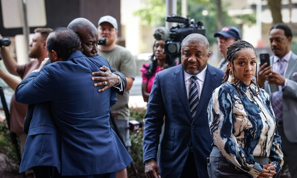 Nationally renown civil rights attorney Benjamin Crump, left, hugs Skip Ross, the father of Colby Ross, following a news conference Wednesday, July 31, 2024, in downtown Dayton regarding the death of Ross when he was struck by a driver involved in a high-speed chase with the Montgomery County Sheriff's Office while stopped at a red light. At right is Dayton attorney Michael Wright and Chenea Ross, the widow of Colby Ross. JIM NOELKER/STAFF