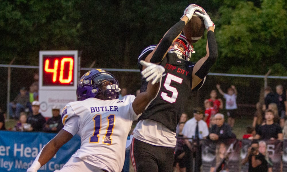 Tippecanoe's Dylan Herndon catches a pass over Vandalia Butler's Davon Smith during the first half of Thursday night's game won by Tipp 25-7. Jeff Gilbert/CONTRIBUTED