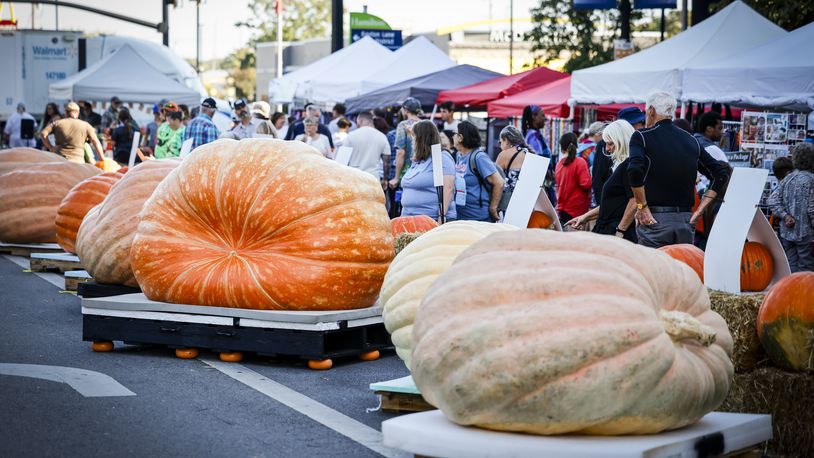 Visitors check out vendor booths, food and beer trucks, and pumpkins of all shapes and sizes on High Street during Operation Pumpkin Friday, Oct. 13, 2023 in downtown Hamilton. NICK GRAHAM/STAFF