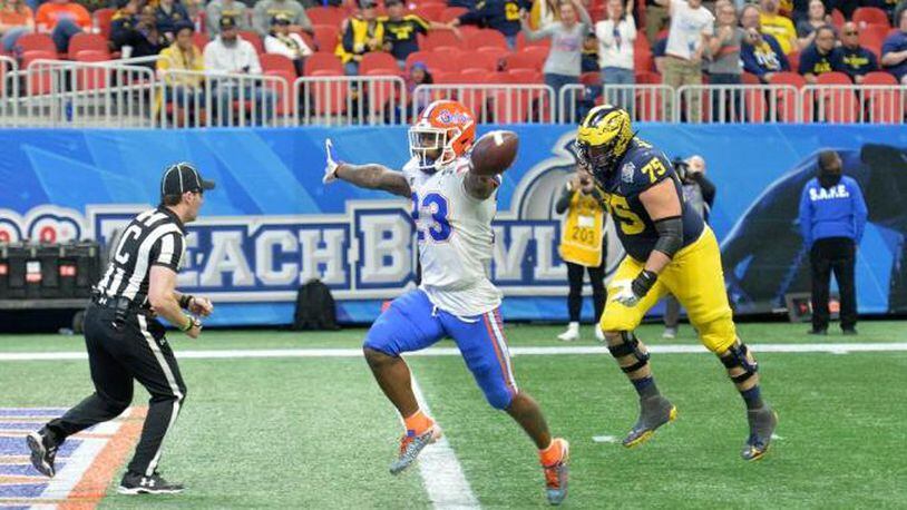 Florida defensive back Chauncey Gardner-Johnson (23) celebrates as he scores a touchdown after he picked up a fumble in the second half of the Chick-fil-A Peach Bowl at Mercedes-Benz Stadium in Atlanta on Saturday, December 29, 2018.