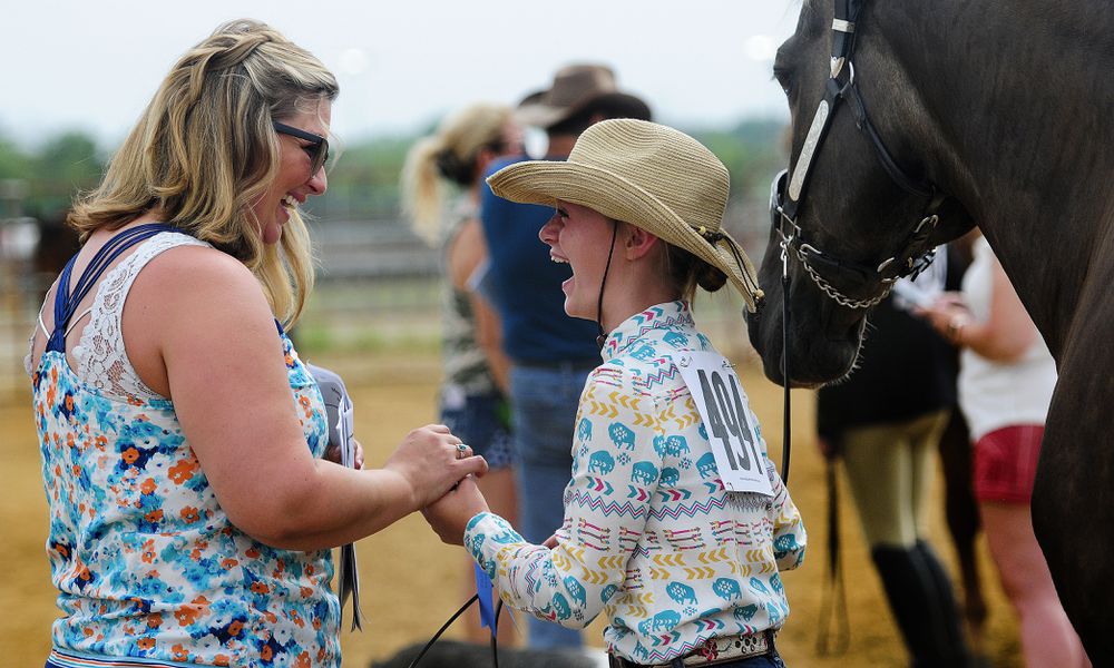 Jami Shell, from Farmersville, congratulates her daughter Liberty Shell, age 10, after winning the Novice Showmanship Competition at the Montgomery County Fair on July 9th, 2024. MARSHALL GOBRY/STAFF